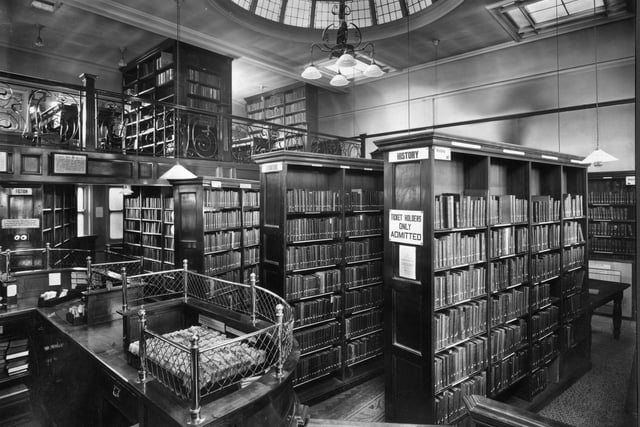 Inside Armley Library. Dating from a time when library users were as strictly ordered as the book stock, a notice states that 'ticket holders only admitted'.