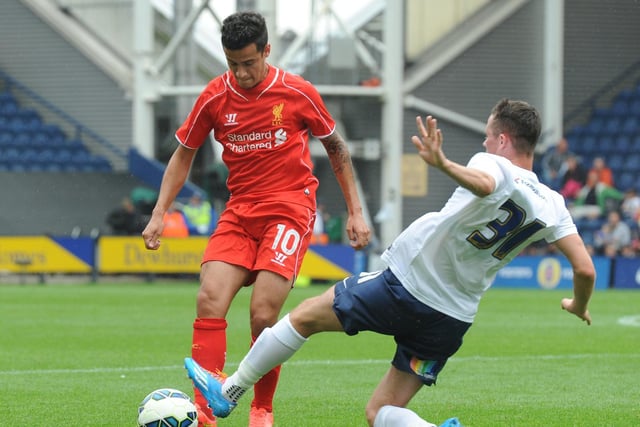 Alan Browne tackles Liverpool's Philippe Coutinho in a pre-season friendly at Deepdale in July 2014