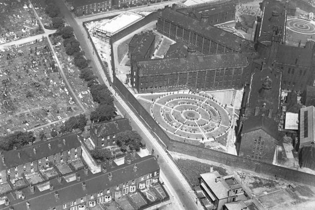 An aerial view of Armley Gaol, built as Leeds Borough Gaol and completed in July 1847. The road from top to bottom across the centre is Hall Lane and New Wortley Cemetery is at the left edge from the middle to the top.