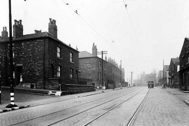 Armley Road looking west towards junction with Branch Road. Junction with Bridlington Street can be seen on the left with a woman on the doorstep of the first property.