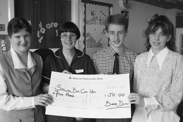 Sister Janet Hadfield receives a 50 cheque raised for Sharoe Green Hospital's baby care unit by sales during a Young Enterprise week at St Cecilia's RC High School, Longridge. She is with, from the left, Catherine Hayhurst, Dominic Ashcroft and Charlotte Hartley