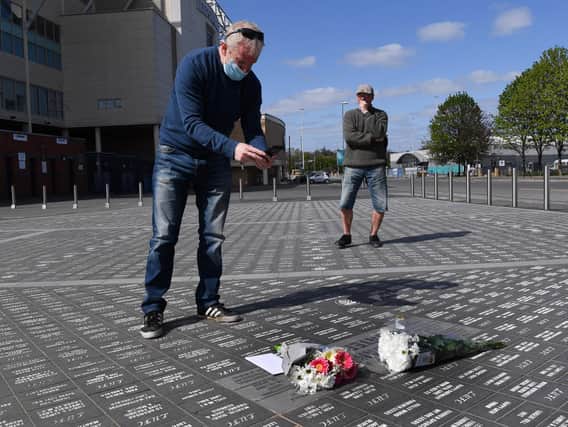 Flowers pile up outside Elland Road in tribute to Leeds United legend Norman Hunter