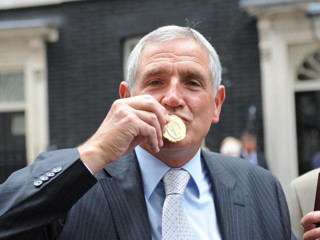 Norman Hunter kisses his medal, presented by Prime Minister Gordon Brown for representing his country in the 1966 World Cup.