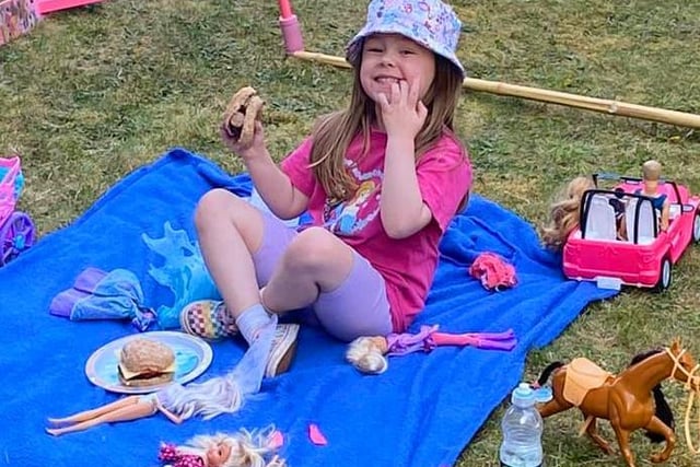 Hope, four, enjoying a picnic with her toys in the garden, sent in by Stacey Halliday.