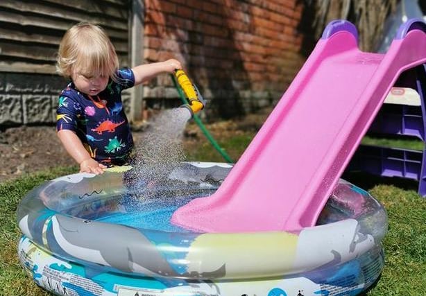 William, two, filling up his own paddling pool to help us all cool down in the sun, sent in by Gemma Purvis.