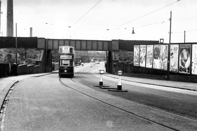 A view showing tram no 160 passing under a railway bridge on Belle Isle Road on its way to Swinegate.