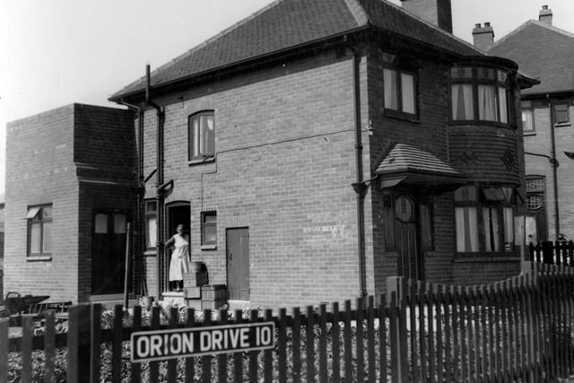 A view of number 6 Orion Drive owned by Ernest Steel, dairyman. Detached house with bay windows, addition to the side of the property is the dairy produce available chalked on the wall 'dairy butter, new milk sold here, new laid eggs'.