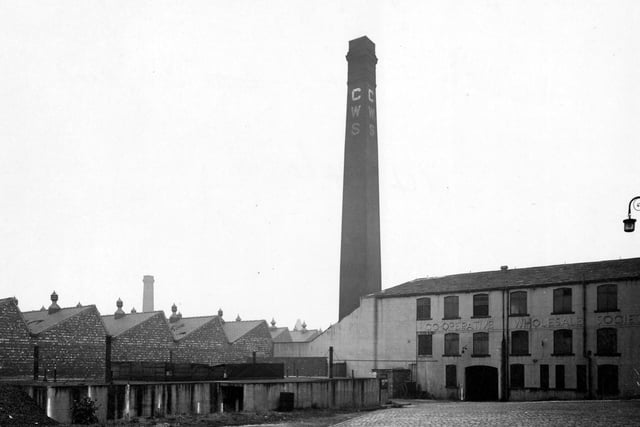Brush factory section of Co-operative Wholesale Society Ltd. showing factory buildings and tall chimney with CWS painted on sides. The site is at 2 Belle Isle Road.
