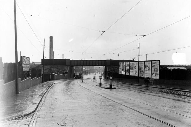 A view looking north to railway bridge over Belle Isle Road, just south of Sandon Place. On the left is 'Arthur B Fielding Ltd.Tailors'.