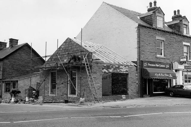 Bradford Road by the junction with Beech Street, seen on the left. Millan Stores, off licence and cigarettes is seen on the right.