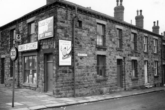 A view of terraced houses, back to backs on Fenton Street at the corner with Bradford Road. Lumb's Off-Licence is on Bradford Road.