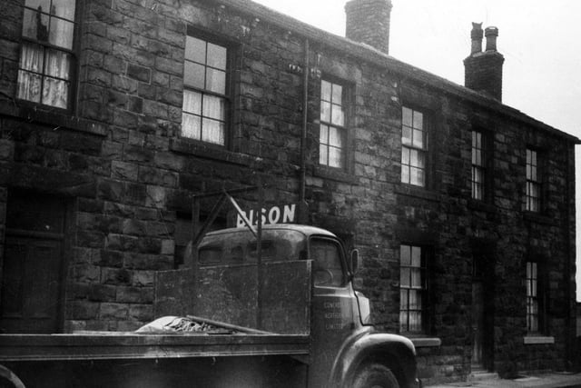 A view of terraced houses on Scarborough Street. A lorry is parked in front of no 43. The lorry has a sign 'Bison' over the cab and Concrete Northern Limited on the door.
