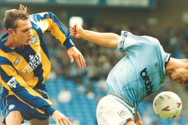 Young striker Noel Whelan battles for the ball with Manchester City's Michael Vonk.
