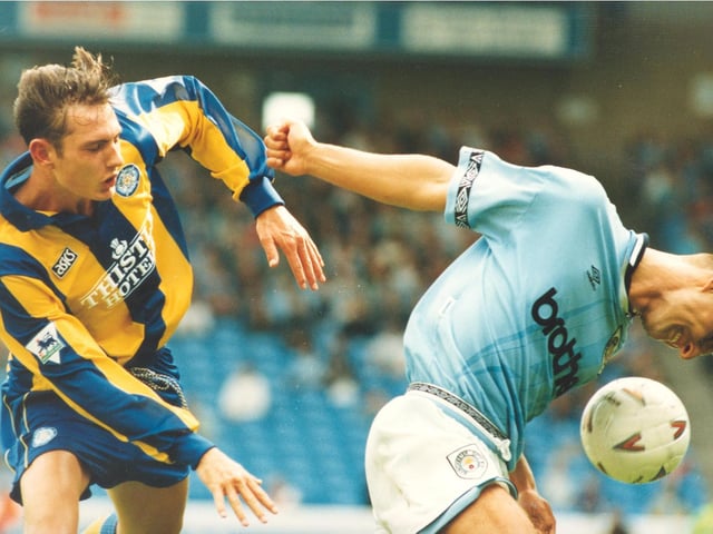 Young striker Noel Whelan battles for the ball with Manchester City's Michael Vonk.