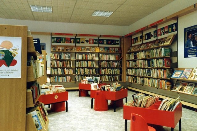 Swinnow Branch Library, taken around the time of its opening in 1987. This view shows the children's corner, with kinderboxes full of picture books in the centre and books for older children on the shelves around.