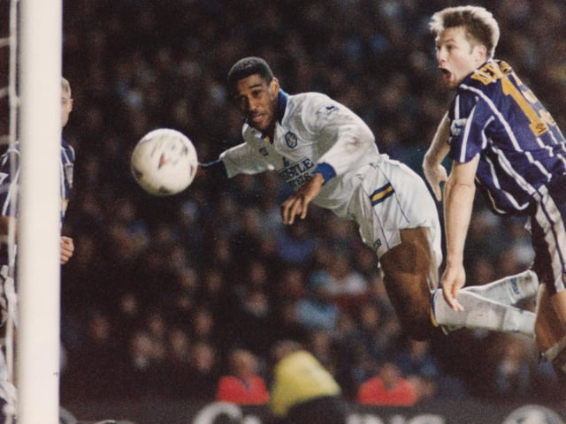 Brian Deane heads towards goal.