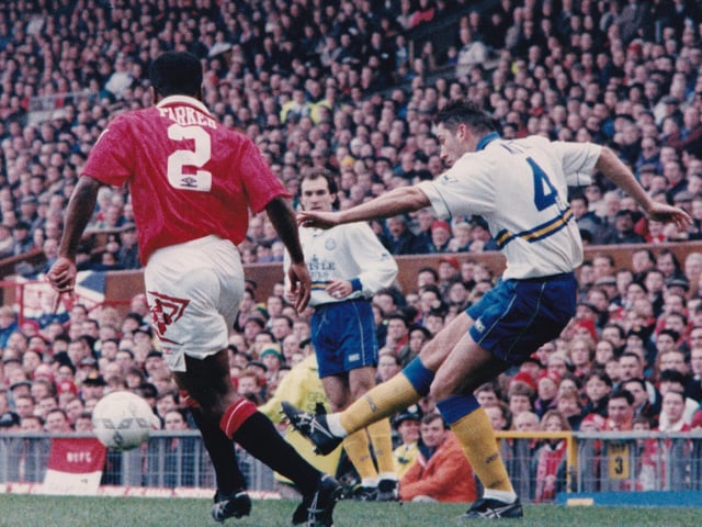 New recruit David White crosses past Paul Parker at Old Trafford.