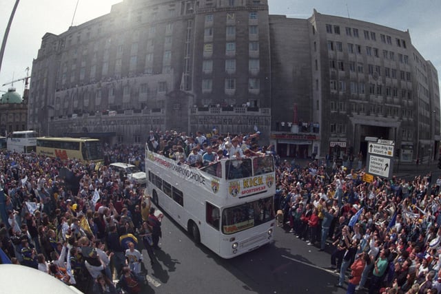 The open top bus makes its way past City Square on its way to Leeds Town Hall.