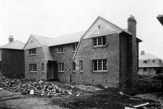 Middleton estate. Houses were built in various styles and sizes to accommodate the needs of tenants. In this view work is still in progress, building tools and materials can be seen.