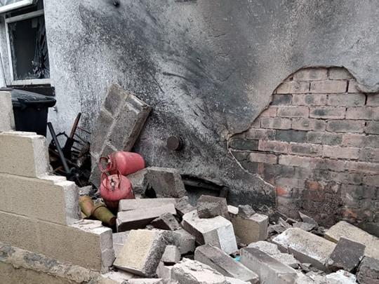 A fire had been started among some rubbish next to the parade of shops and had caused a gas canister to explode, damaging nearby properties - including the distraught family's.