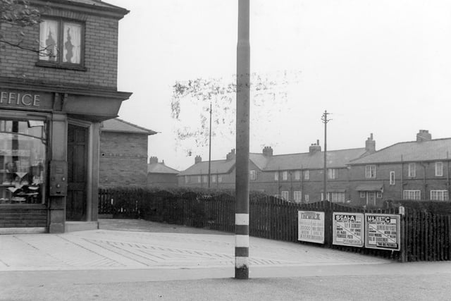 The corner of Middleton Park Post Office on Middleton Park Avenue. There is what appears to be a stamp vending machine at the doorway, and a tall street light outside.
