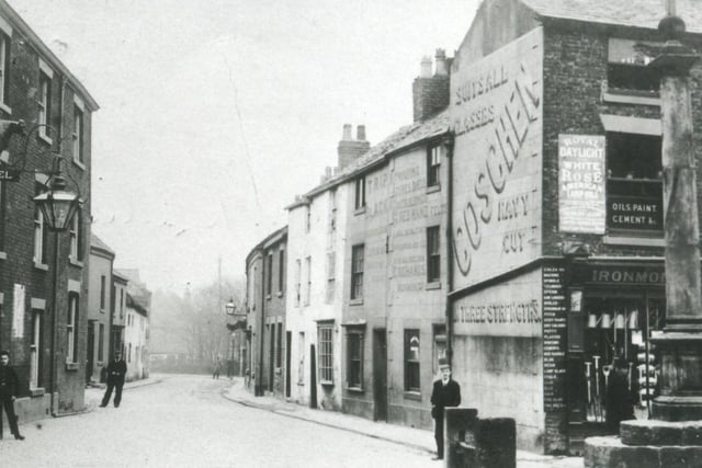 A 1904 view down Blackpool Old Road. The Bull on the left and building on the right, an ironmongers, which advertises a brand of cigarettes which 'suits all classes', remain along with the stocks and the market cross.