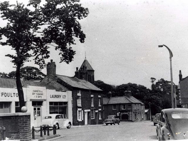 This typical 1950s scene, shows Queens Square looking towards Chapel Street and Higher Green. The cottages right of centre still remain.