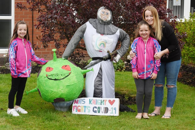 Kerry Richardson and twins Erin, left, and Isla, both seven, with their scarecrow display.