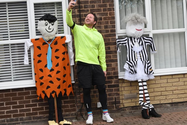 The Wigan Runner Matthew Melling takes a look around Hawkley Hall to see the scarecrows during his run.