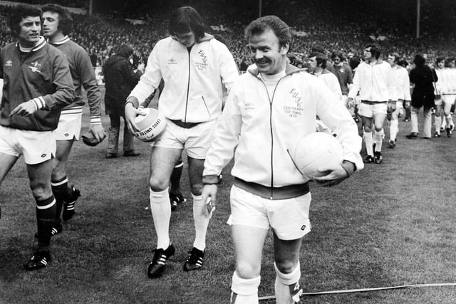A beaming Billy Bremner leads the team out at Wembley.