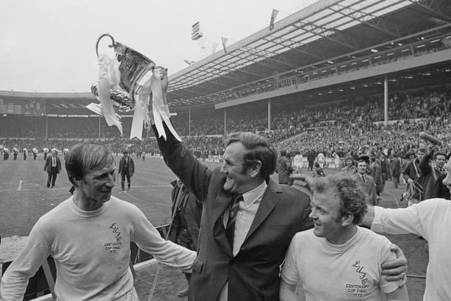 Don Revie lifts the FA Cup trophy. Also shown are Jack Charlton (left), Billy Bremner and Paul Reaney (far right).
