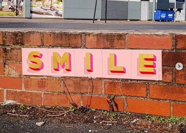 Smile - This uplifting, tiled street street sign has been inspiring residents in Ashton to do just that. Credit: Vews_One