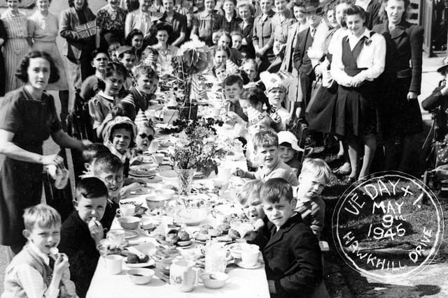 A street party on Hawkhill Drive in Crossgates. It is worth noting that the crowd standing round the table are mostly female. The male residents would have been serving in the armed forces.