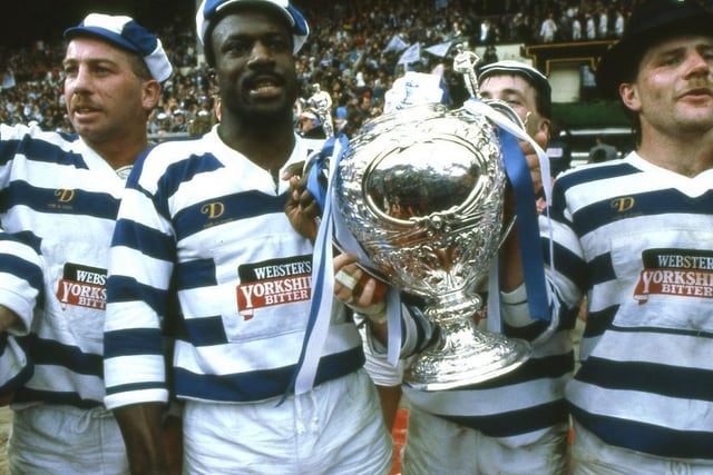 Paul Dixon, Scott Wilson, Wilf George and Mick Scott hold the Challenge Cup trophy after Halifax's 19-18 win against St Helens at Wembley in 1987.