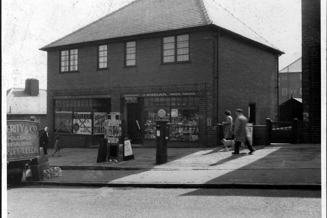 Two modern shops on Brander Road, part of the Gipton Estate. The shop on the right is J. Whelan, newsagent and tobacconist, it is also a Post Office.