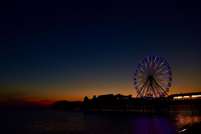 Blackpool's big wheel set against the flaming edges of the setting sun and a velvet night sky