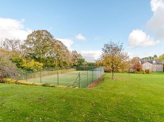 Outside, the property is approached through double electric entrance gates opening into an extensive driveway and forecourt providing ample parking for numerous vehicles and in turn giving access to the three car garage with extensive storage loft.