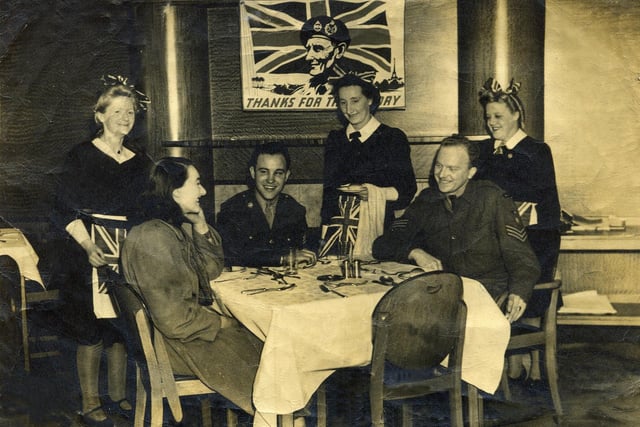 VE Day at a Blackpool cafe, the waitresses are wearing Union Jack aprons and hair bows