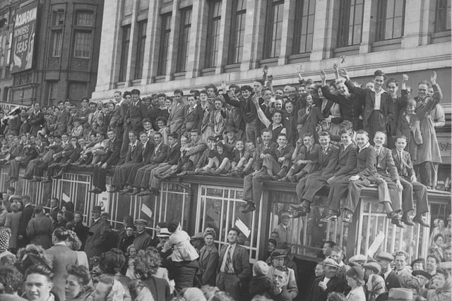Crowds on Blackpool promenade outside the Woolworth building celebrate the end of the war in Europe