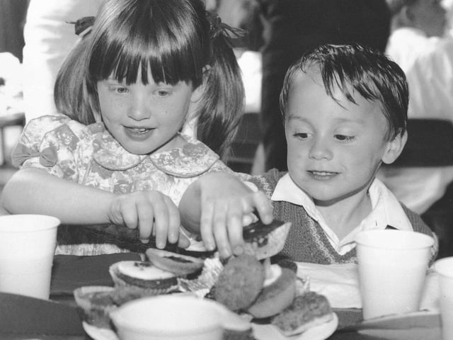 Emma Lingard and Daniel Smith tuck in at Cayton School's party.