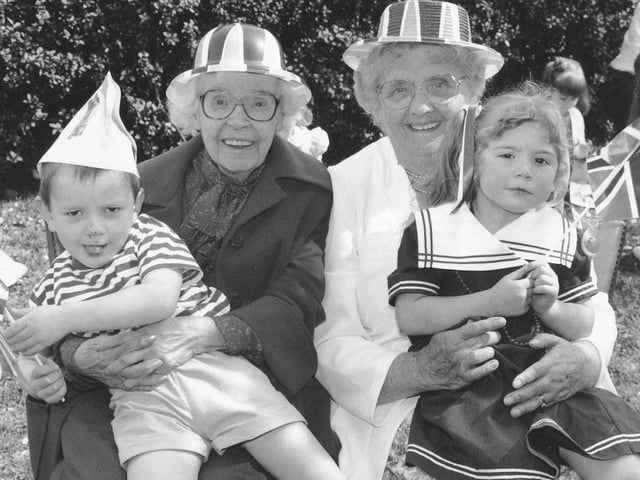 Mary Ollerenshaw and Florence Hall with children Gary Walker and Jessica Langley at Childhaven Nursery's street party.
