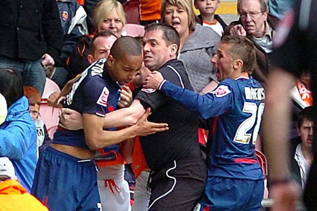 Referee Phil Dowd breaks up a scuffle