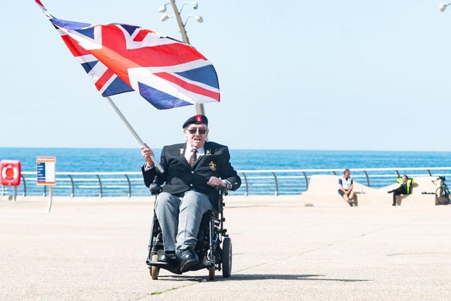 Veteran George Brown, 76, from Blackpool and formerly of the Kings Regiment, waves a Union Flag on Blackpool Promenade