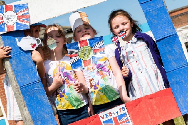 Pupils pose in a hand-made selfie booth at Bispham Endowed Church of England Primary School for VE Day 2020