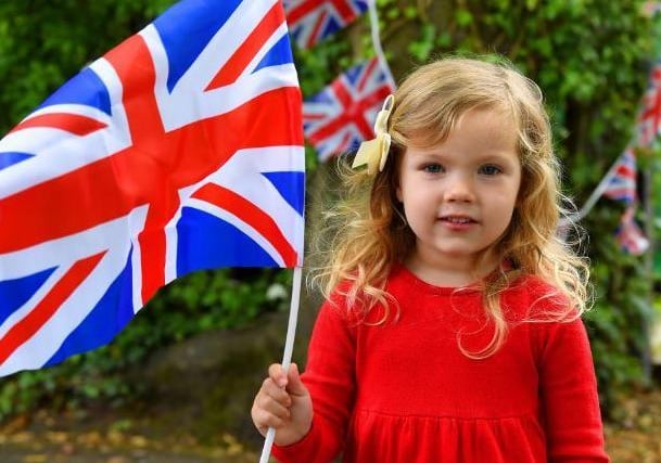 Hattie Taylor, 3, proudly flies the Union Jack in celebration of the 75th anniversary of Victory in Europe Day in Rawsthorne Road, Penwortham