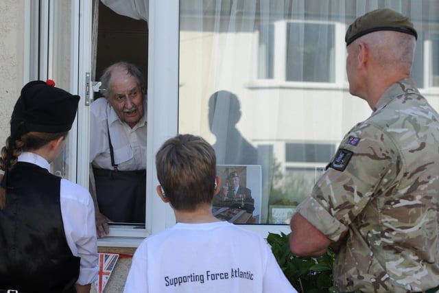 D-Day veteran John 'Jack' Rushton talks to Lft Col Richard Hall from Army Foundation College and residents who attended the Beech Road street party.