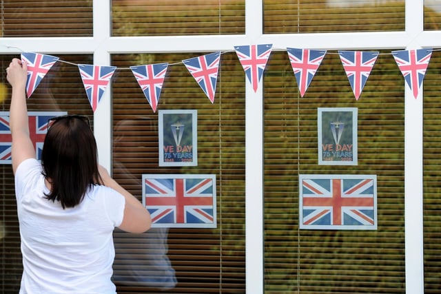 A Beech Street resident is pictured putting up the bunting for the big celebration.