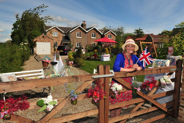 Artist Julie McCready pictured with her garden displays in Bickerton ahead of their VE Day street party.