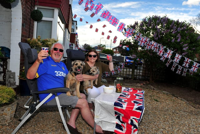 Steve and Fiona Green pictured with their dogs in their garden surrounded by bunting at the St Johns Drive street party.