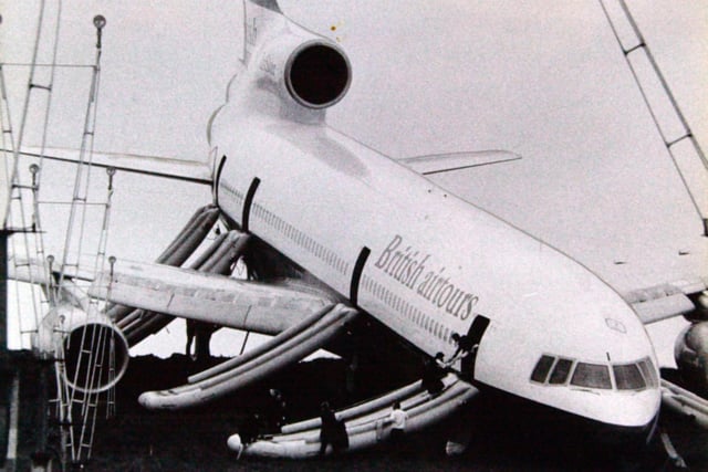 The aircraft over-ran the runway, which was wet from a recent rain shower, and came to a stop in a sloping field just beyond the boundary of the airfield. An evacuation was ordered, and all on board escaped with only minor injuries.